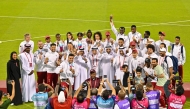 Qatar Athletics Federation President Mohammed Issa Al-Fadala celebrates with Team Qatar's medal winners.