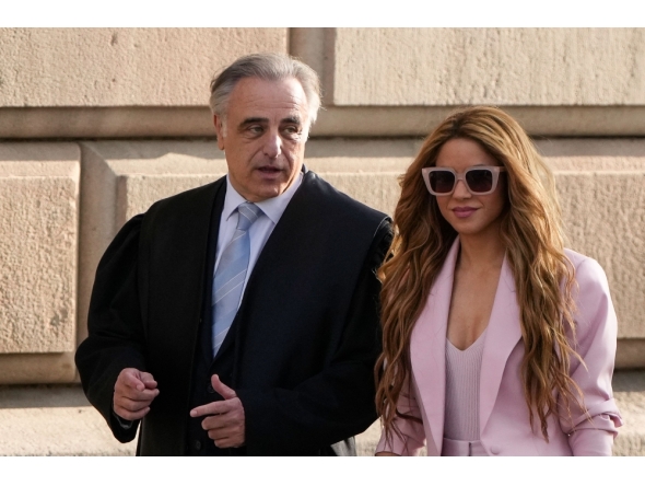 (FILES) Colombian singer Shakira arrives with her lawyer Pau Molins (L) at the High Court of Justice of Catalonia for her trial on tax fraud, in Barcelona on November 20, 2023. (Photo by Pau Barrena/ AFP)