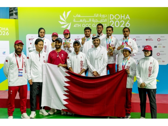 Qatar's medal-winning archers and officials pose for a photo.