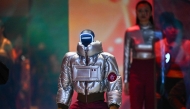 A humanoid robot and a model present creations at Galaxy Corporation's 