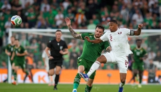 Ireland’s Troy Parrott (left) battles for the ball with Qatar’s Pedro Miguel. (AFP)