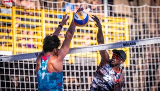 Qatar's Ahmed Tijan (right) shoots to score a point.