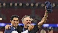 Paris Saint Germain's Qatari president Nasser al-Khelaifi (L) and Paris Saint-Germain's Spanish head coach Luis Enrique celebrate winning the UEFA Champions League final football match between Paris Saint-Germain (PSG) and Arsenal FC at the Puskas Arena in Budapest on May 30, 2026. (Photo by Odd Andersen/ AFP)