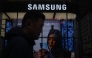 A man walks past a Samsung store in Seoul on May 28, 2026. (Photo by Pedro Pardo / AFP)