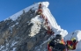 (Files) This photograph taken on May 20, 2026, shows mountaineers climbing a slope lined up during their ascent from the Hillary Step to summit Mount Everest in Nepal. (Photo by Furte Sherpa / AFP)