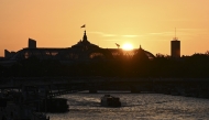 A tourist boat sails along the Seine river at sunset with the Grand Palais in the background, in Paris on 26 May 2026. (Photo by Christophe DELATTRE / AFP)
