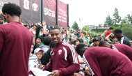 Qatar midfielder Assim Madibo signs autographs for young fans in Santa Barbara, California, on Friday. 