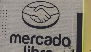 Mercado Libre is displayed on an advertising wall in Mexico City on October 1, 2025. (Photo by Yuri CORTEZ / AFP)