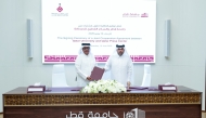 Director General of the Qatar Press Center Sadiq Mohammed Al Amari and Vice President for Academic Affairs at Qatar University Prof Ibrahim Mohammed Al Kaabi exchanging documents after signing the agreement.