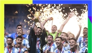 Argentina’s Lionel Messi lifts the trophy after winning the FIFA World Cup Qatar 2022 title, in this December 18, 2022 file photo. (AFP)