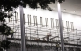 Workers build scaffolding near the signage for the 