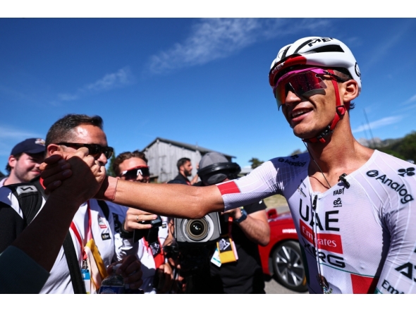 UAE Team Emirates XRG's Mexican rider Isaac Del Toro Romero celebrates winning the 8th and final stage of the Tour Auvergne-Rhone-Alpes cycling race, 120,1km between Beaufort and Plateau de Solaison, in the French Alps on June 14, 2026. (Photo by Anne-Christine POUJOULAT / AFP)