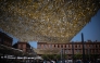 People walk through the Capitole square covered by an installation to provide shade, in Toulouse on June 19, 2026. Photo by Lionel BONAVENTURE / AFP