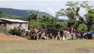 This AFPTV screengrab shows residents affected by Hurricane Melissa on October 29, 2025 receiving humanitarian aid from Caritas volunteers, on June 13, 2026. (Photo by AFPTV STRINGER / AFP)