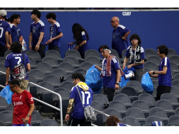 Japan fans clear trash in the stands during the FIFA World Cup 2026 match at Dallas Stadium on June 14, 2026 in Arlington, Texas. Michael Steele/Getty Images/AFP 