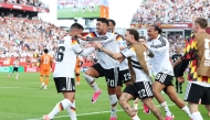 Deniz Undav (left) celebrates with teammates after scoring Germany's second goal.