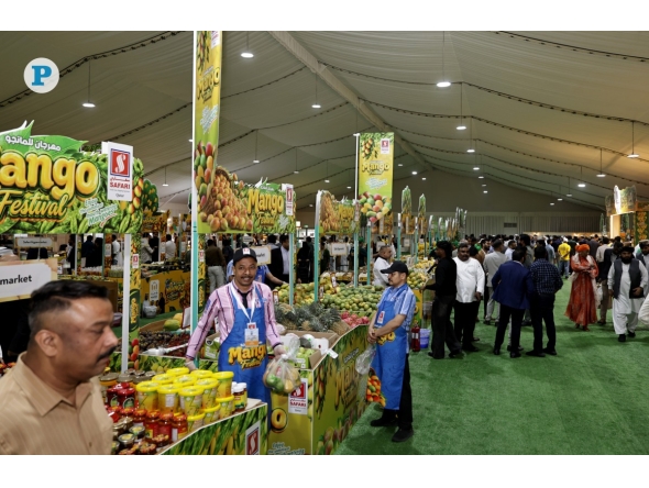Stalls in Souq Waqif displaying fresh mangoes and other related products from India.
