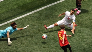 Iran's goalkeeper #01 Alireza Beiranvand makes a save past Belgium's defender #05 Maxim De Cuyper during the 2026 World Cup Group G football match between Belgium and Iran at the Los Angeles Stadium in Inglewood on June 21, 2026. (Photo by Etienne Laurent / AFP)