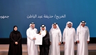Undersecretary of the Ministry of Awqaf and Islamic Affairs Sheikh Khalid bin Mohammed bin Ghanem Al Thani honours a graduate during the ceremony, while Undersecretary of the Ministry of Education and Higher Education Dr. Ibrahim bin Saleh Al Nuaimi, looks on. Pic: Salim Matramkot/The Peninsula