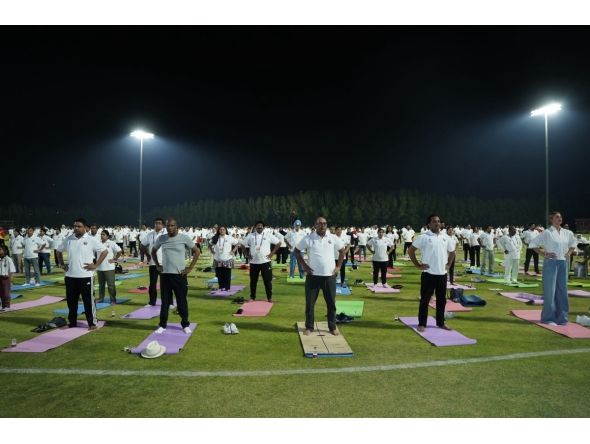 Ambassador of India to Qatar H E Vipul with other participants practising yoga.