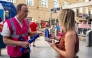 A staff member hands out flasks to customers as part of a distribution of water bottles, hats and fans at the Saint-Charles railway station in Marseille on June 22, 2026. (Photo by Miguel Medina / AFP)