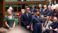 A handout photograph released by the UK Parliament shows new Labour Party MP for Makerfield, Andy Burnham (C) arrives to be sworn in after his win in the recent by-election, in the House of Commons in London on May 22, 2026. (Photo by UK Parliament / AFP) 