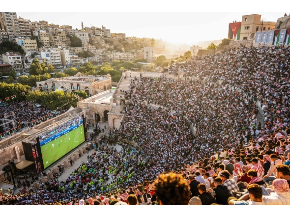 Jordanian football fans gather to watch on giant screens their national team's 2026 World Cup Group J football match against Algeria at Amman's 2nd-century Roman amphitheatre early on June 23, 2026. (Photo by George SAIF / AFP)