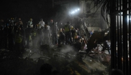 Rescue workers and volunteers search through the rubble of a collapsed building in Caracas on June 25, 2026, following a series of earthquakes. Photo by Maryorin Mendez / AFP