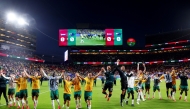 Australia players celebrate after qualifying for the Round of 32. (AFP)