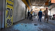 Syrian security forces gather at the site of an explosion at a cafe in the capital Damascus on July 2, 2026. A bomb went off at a cafe in central Damascus on on July 2, killing at least five people and wounding 16, Syrian authorities said. (Photo by LOUAI BESHARA / AFP)