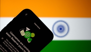 This illustration photograph taken on July 2, 2026, shows the new upcoming Usernamer feature on US instant messaging software WhatsApp, displayed on a smartphone with the backdrop of India's national flag in New Delhi. (Photo by Manan Vatsyayana / AFP)