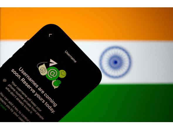 This illustration photograph taken on July 2, 2026, shows the new upcoming Usernamer feature on US instant messaging software WhatsApp, displayed on a smartphone with the backdrop of India's national flag in New Delhi. (Photo by Manan Vatsyayana / AFP)