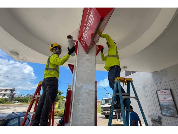 Workers secure a gas station ahead of the arrival of the forecasted Super Typhoon Bavi in Saipan, Northern Mariana Islands, on July 3, 2026. (Photo by Mark Rabago / AFP)