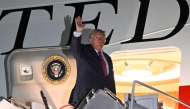 US President Donald Trump waves as he boards Air Force One at Ellsworth Air Force Base, South Dakota (Photo by Mandel Ngan/ AFP)