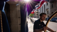 People walk through downtown Philadelphia after news that the Semiquincentennial Independence Day Parade has been canceled due to extreme heat in Philadelphia, Pennsylvania. (Photo by SPENCER PLATT / AFP)