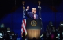 US President Donald Trump raises his fist while speaking at 