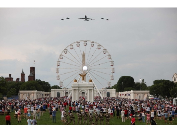 The new Air Force One escorted by US Air Force F-22 Raptors flies over the National Mall during the 