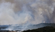 Canadair CL-415 aircraft of France's Civil Security services drop water on a wildfire at the Col des Auzines, near Trevillach, southern France, on July 5, 2026.  (Photo by Matthieu RONDEL / AFP)