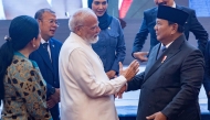 India's Prime Minister Narendra Modi (centre L) shakes hands with Indonesia's President Prabowo Subianto (R) during his visit at the parliament building in Jakarta on July 7, 2026. (Photo by KRISTIANTO PURNOMO / AFP)