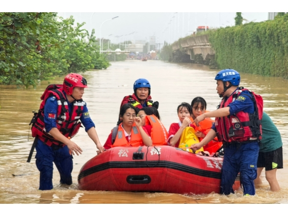 Rescue workers evacuate flood-affected students in Guigang, in China's southern Guangxi region, on July 8, 2026. (Photo by CN-STR / AFP)