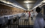 Workers and volunteers, rest before preparing to pack the Bayeux Tapestry in a crate for transfer to the British Museum, at the Bayeux Tapestry Museum, in Bayeux, northwestern France, on September 18, 2025. Photo by Lou Benoist / Pool / AFP
