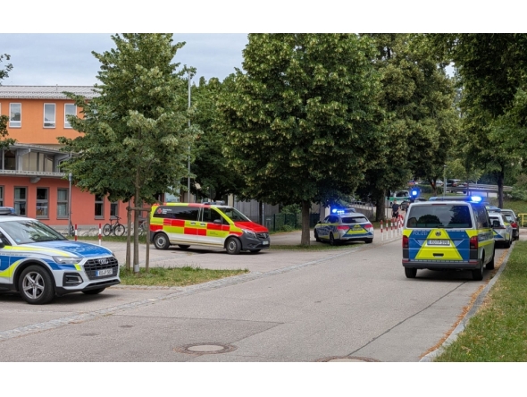 Cars by Police and rescue personnel are parked near the secondary school Schongau, in the southern German state of Bavaria, where several people have been wounded and a suspect arrested in an attack on July 8, 2026.  (Photo by Christoph PETERS / DPA / AFP)