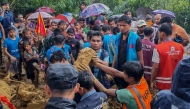 Bangladesh rescue personnel and volunteers work at the site of a landslide triggered by heavy rains at a school in the Kutupalong refugee camp in Cox's Bazar on July 8, 2026. (Photo by AFP)
 