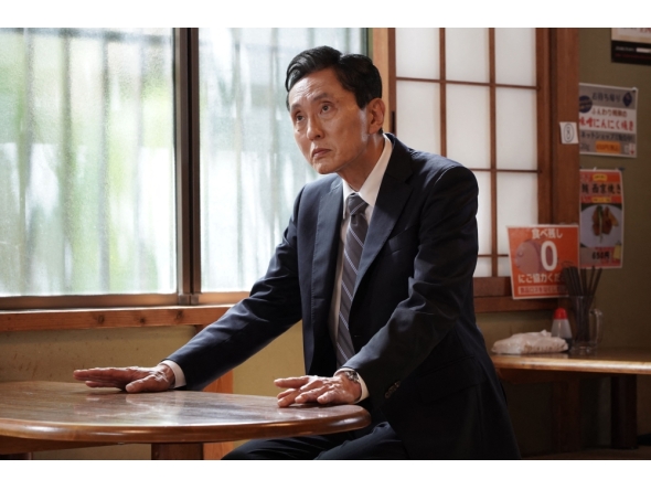 Japanese actor Yutaka Matsushige performs a dining scene during the filming of an episode of the TV drama series 