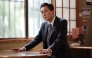 Japanese actor Yutaka Matsushige performs a dining scene during the filming of an episode of the TV drama series 