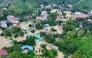 This aerial photograph shows partially submerged residential buildings following heavy rains in Bangladesh's Bandarban town on July 11, 2026. (Photo by Syed Amir Hosain Masum / AFP)