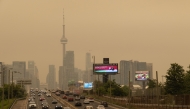 Wildfire smoke from northwestern Ontario fills the sky in Toronto, Canada, on July 15, 2026. (Photo by Zou Zheng/Xinhua)