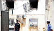 Police officers stand guard at the entrance of an orphanage following a fire in the Mohammadia suburb of Algiers on July 16, 2026 (Photo by AFP)