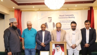 Participants observe a moment of silence during the condolence meeting.
