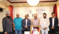 Participants observe a moment of silence during the condolence meeting.
